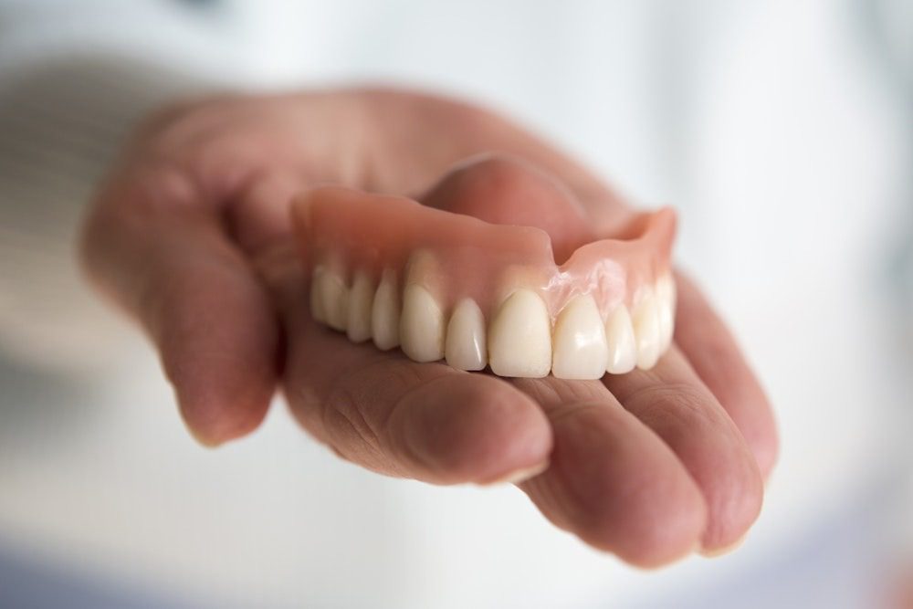 Dentures held in a hand