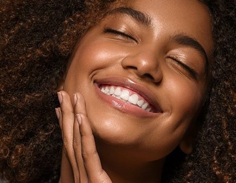 Smiling person with curly hair