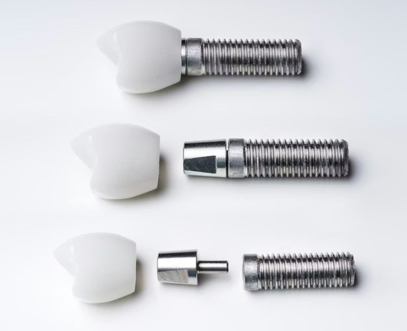 Disassembled dental implants showing parts