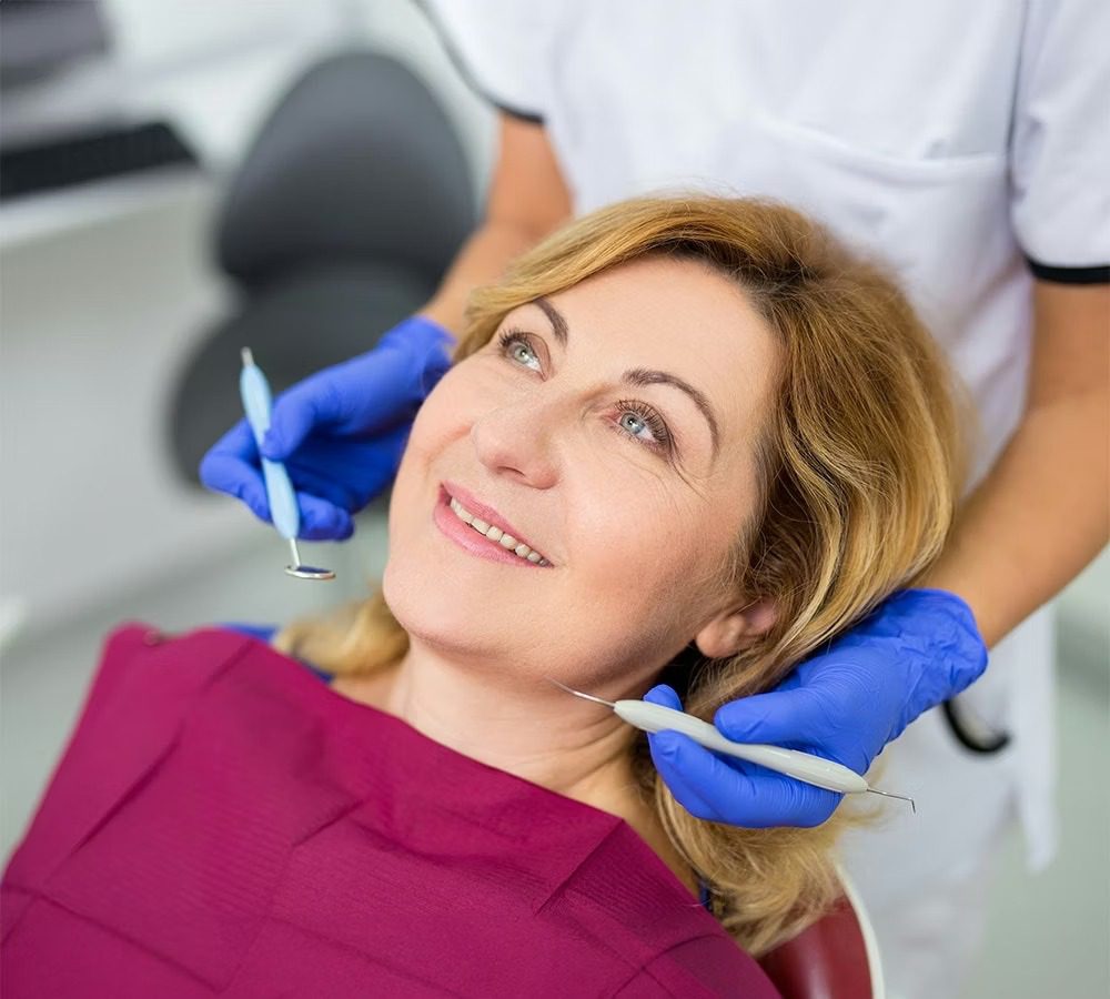 Dental hygienist with patient in chair