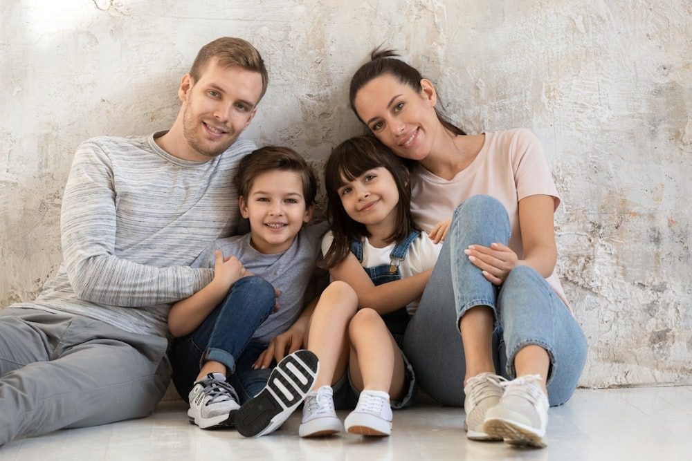 Smiling parents with two young children