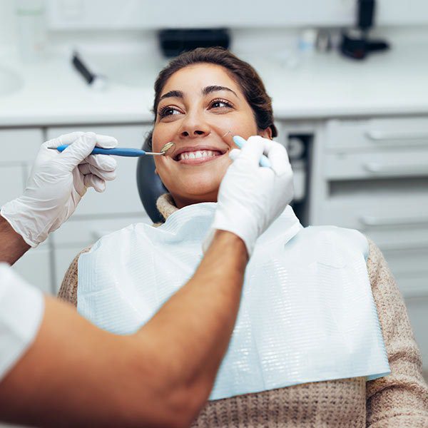 Woman smiling during a dental checkup