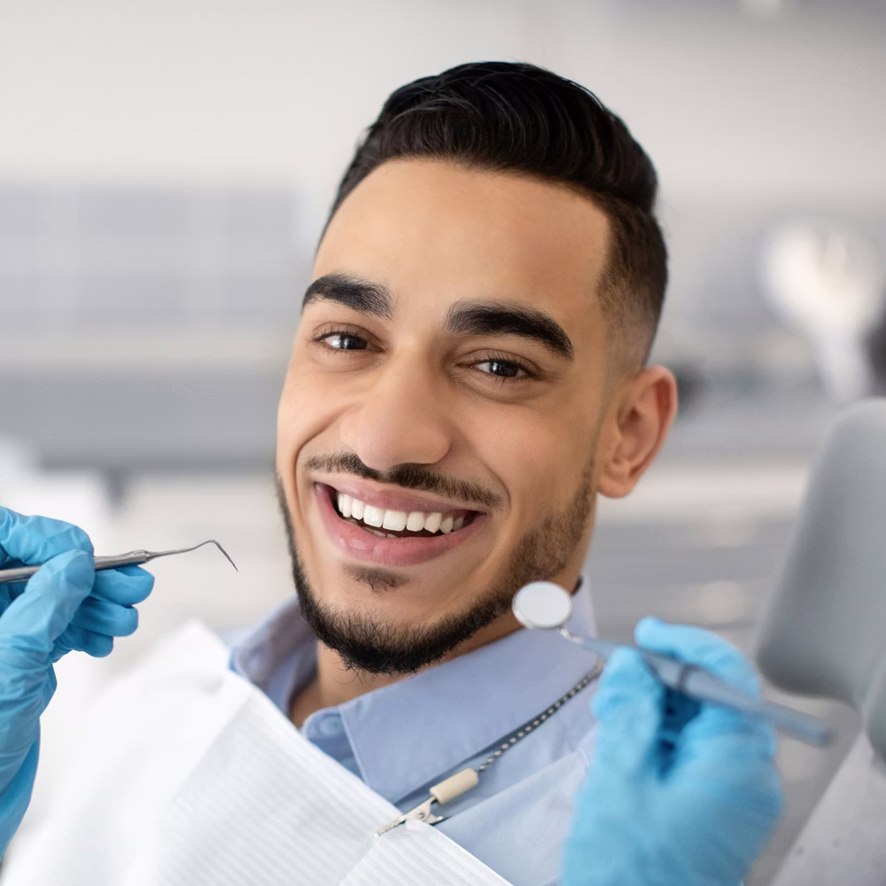 Man with dental tools smiling